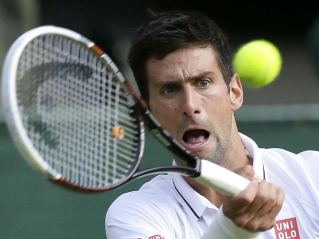 Novak Djokovic returns to Tommy Haas during their Wimbledon round four match in London. AP Photo