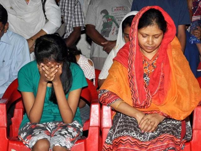 Suman Lata Balihar, wife of Amarjit Balihar, and her daughter mourn at their residence in Ranchi. AP Photo
