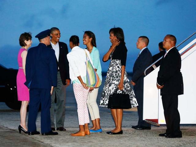 US President Barack Obama (3rd L), first lady Michelle Obama (3rd R) and their daughters Sasha (4th L) and Malia return to Andrews Air Force Base near Washington. (Reuters)