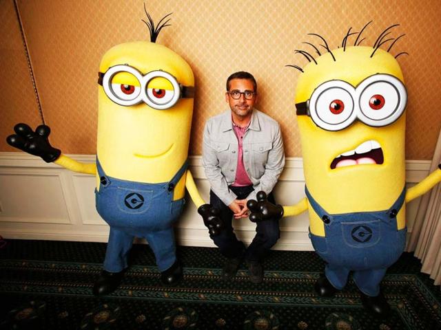 Actor Steve Carell poses with two life-size minion characters while promoting his upcoming movie "Despicable Me 2" in Los Angeles, California. (Reuters)