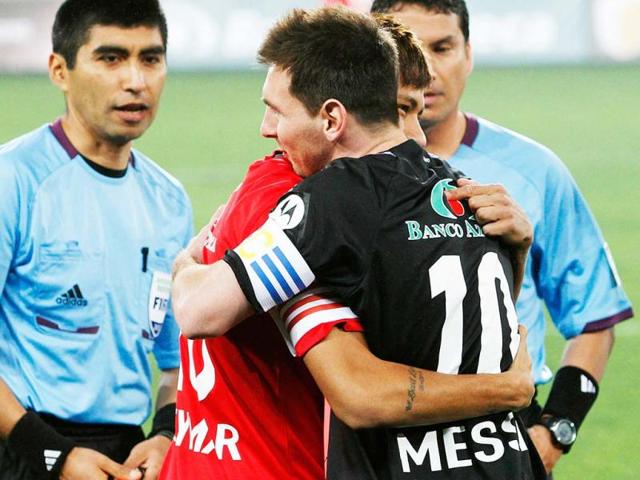Argentina's Lionel Messi (R) and Brazil's Neymar embrace each other before an exhibition soccer match called the "Giants Duel: Messi and friends vs Rest of the World" at the National Stadium in Lima. (Reuters)