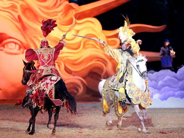 Riders symbolizing princes willing to conquer Apollo, perform in a mythological stage during the show "Les Chevaux du soleil" (Sun's horses) at Le Grand Carrousel Royal in Versailles, Paris. AFP