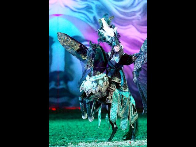 Riders symbolizing princes willing to conquer Apollo, perform in a mythological stage during the show "Les Chevaux du soleil" (Sun's horses) at Le Grand Carrousel Royal in Versailles, Paris. AFP