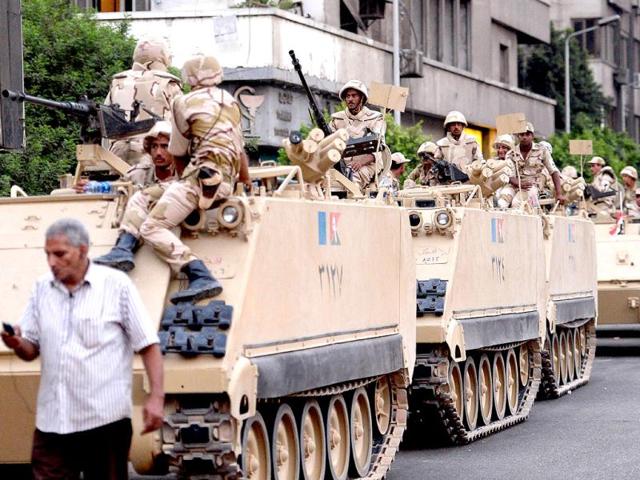 Egyptian army soldiers sit on top of armoured personnel carriers (APC) in Cairo. (AFP)