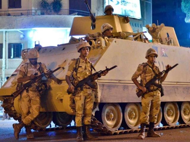 Egyptian army soldiers patrol the streets outside Cairo University after a broadcast saying that the army will temporarily be taking over from president Morsi. AFP Photo