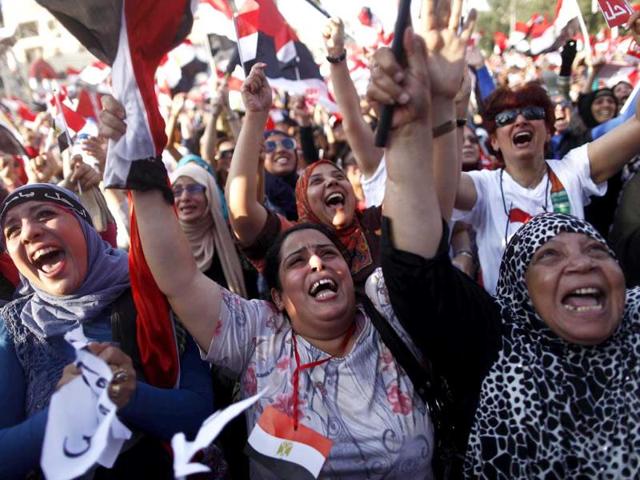 Egyptian women shout slogans against president Mohammed Morsi as they join hundreds of thousands demonstrating outside the Egyptian presidential palace in Cairo, Egypt. AFP Photo