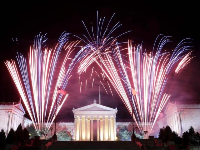 Fireworks explode over the Philadelphia Museum of Art and a statue of George Washington during Independence Day celebrations in Philadelphia. (AP)