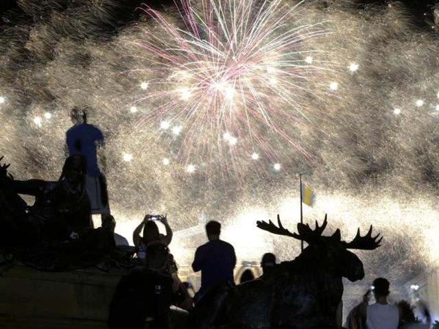 Fireworks explode over the Philadelphia Museum of Art and a statue of George Washington during Independence Day celebrations in Philadelphia. (AP)
