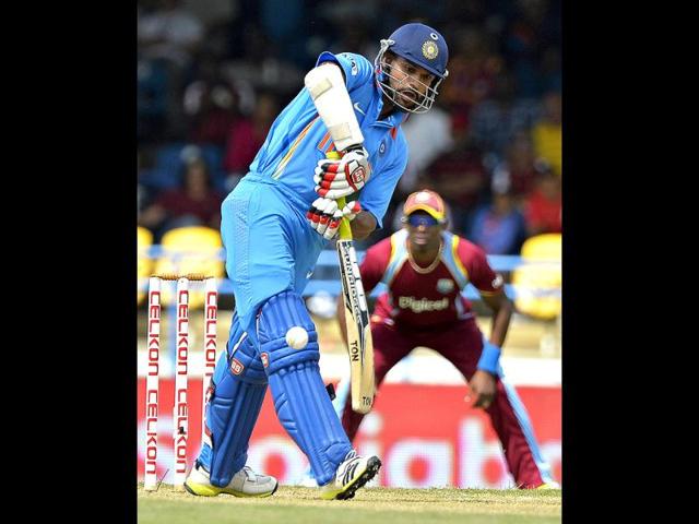 Shikhar Dhawan plays a shot during the fourth match of the Tri-Nation series between India and West Indies at the Queen's Park Oval in Port of Spain. (AFP)