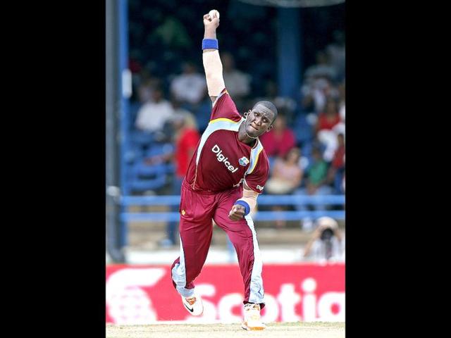 West Indies' Darren Sammy bowls during the Tri-nation series cricket match against India in Port-of-Spain, Trinidad. (AP)