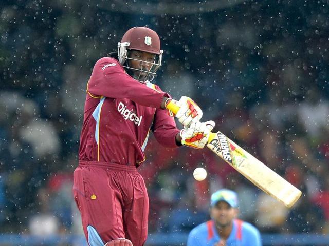 West Indies batsman Chris Gayle plays a shot off bowler Bhuvneshwar Kumar to be caught out during the fourth match of the Tri-nation series between India and West Indies at the Queen's Park Oval in Port of Spain. (AFP)
