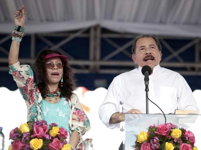 Nicaragua's President Daniel Ortega (R) speaks as his wife Rosario Murillo gestures during a ceremony marking the 34th anniversary of the withdrawal to Masaya in Nicaragua. (AP)