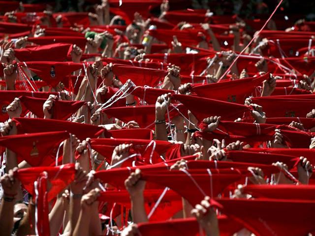 Revellers hold up their red scarves during the start of the San Fermin festival in Pamplona, Spain. Reuters