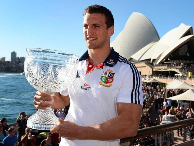 British and Irish Lions captain Sam Warburton holds the Tom Richards Cup in front of the Sydney Opera House, the day after defeating the Australian Wallabies, in Sydney. AFP