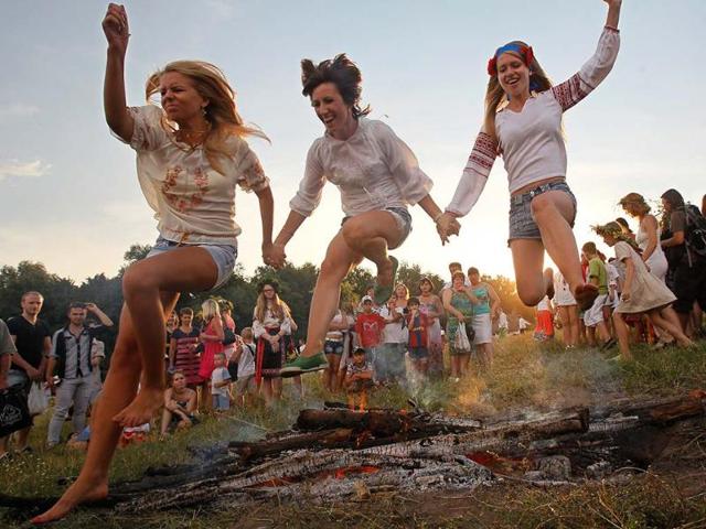 People jump over a campfire during a celebration of the traditional Ivana Kupala (Ivan the Bather) holiday near Kiev. Reuters