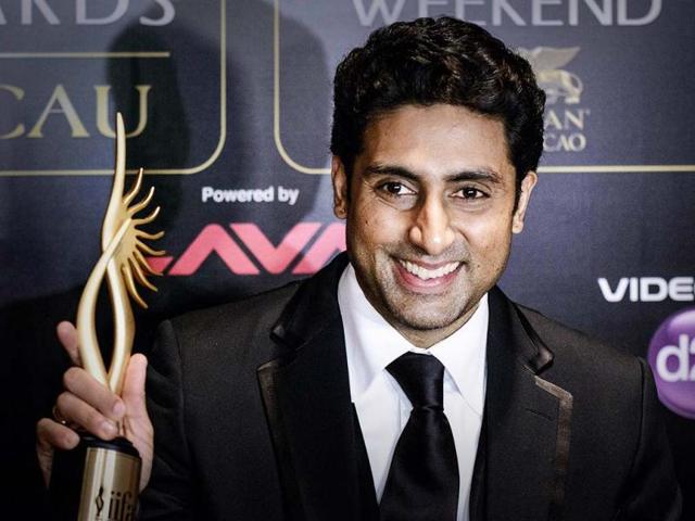 Happy and he knows it: Abhishek Bachchan holds up his trophy after winning the award for best performance in a comic role for Bol Bachchan at the IIFA awards.
