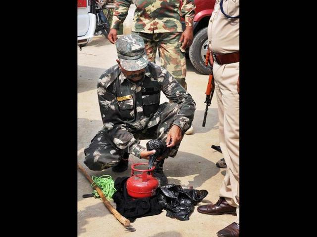 Security personnel handling a cane bomb, recovered from Buddhist Tergar Monastery at the Mahabodhi Temple in Bodh Gaya. PTI