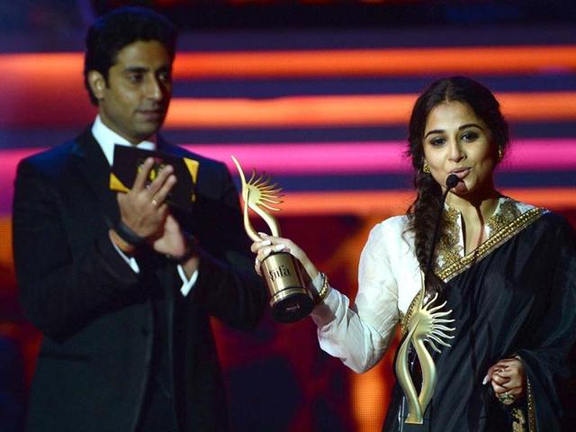 Used to it now: Vidya Balan, who had won the IIFA award last year for her film The Dirty Picture, won it yet again for Kahaani and the lady's certainly on a hatrick. Presenter and former co-star Abhishek Bachchan looks on happily.