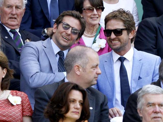 Gerard Butler, right, and Bradley Cooper watch Wimbledon men's singles final match between Andy Murray and Novak Djokovic in Wimbledon, London. AP