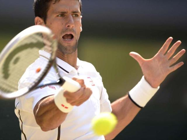 Novak Djokovic returns against Andy Murray during the Wimbledon men's singles final in London. AFP