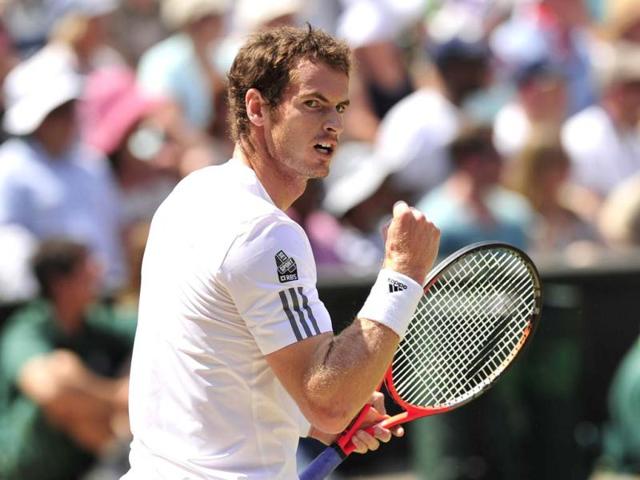 Andy Murray celebrates breaking the serve of Novak Djokovic in the first set during the men's singles final of Wimbledon Championships tournament in Wimbledon. AFP
