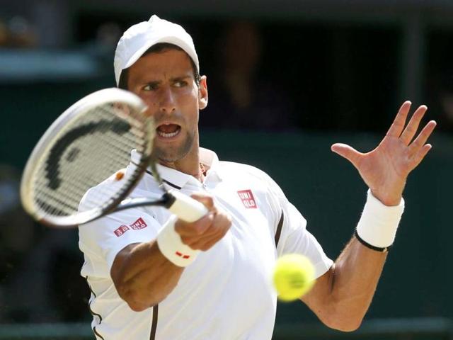 Novak Djokovic of Serbia hits a return to Andy Murray of Britain during their men's singles final match of Wimbledon in London. Reuters