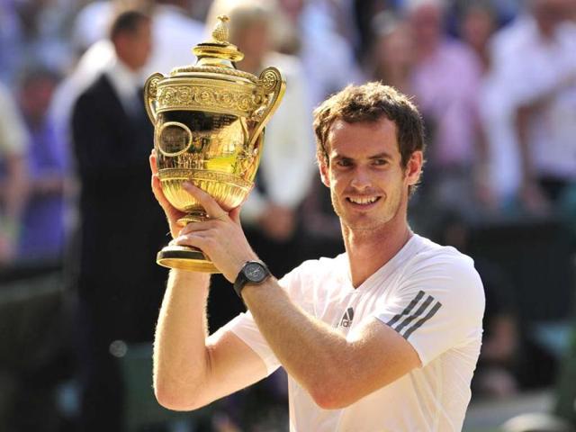Andy Murray raises the winner's trophy after beating Novak Djokovic in the Wimbledon men's singles final in London. AFP