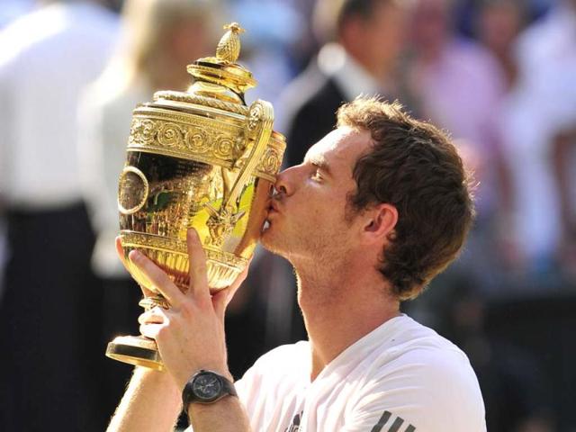 Andy Murray raises the winner's trophy after beating Novak Djokovic in the Wimbledon men's singles final in London. AFP Photo