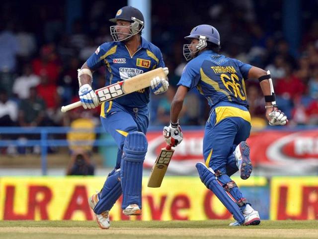 Sri Lankan cricketers Lahiru Thirimanne (R) and Kumar Sangakkara take a single during the fifth match of the Tri-Nation series between Sri Lanka and West Indies at the Queen's Park Oval in Port of Spain. AFP Photo