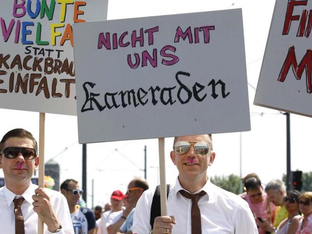 Revellers protest with signs reading, 'Not with us, comrades' at the Christopher Street Day (CSD) parade in Cologne, Germany to demonstrate for the rights of all lesbian, gay, bisexual, transgender and transsexual people. Reuters