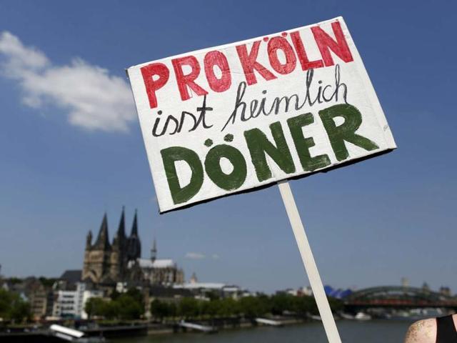 A reveller holds a sign at the Christopher Street Day parade in Cologne to demonstrate for the rights of all lesbian, gay, bisexual, transgender and transsexual people. Reuters