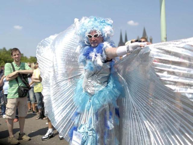 A reveller holds a sign at the Christopher Street Day parade in Cologne to demonstrate for the rights of all lesbian, gay, bisexual, transgender and transsexual people. Reuters