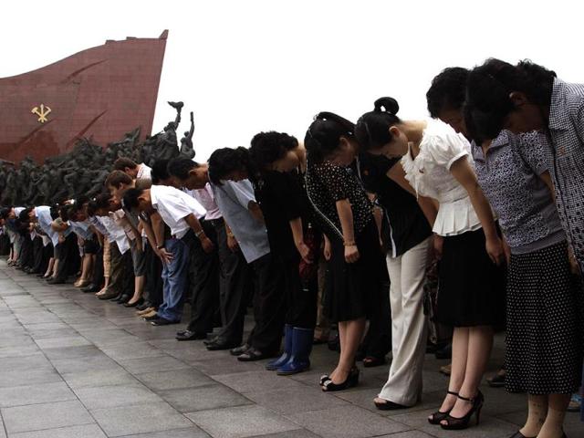 North Koreans and foreigners bow to show their respect to late North Korean leaders Kim Il Sung and Kim Jong Il on the the 19th anniversary of Kim Il Sung's death in Pyongyang, North Korea. (AP)