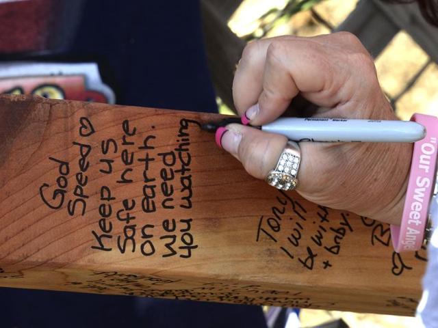 A memorial message is written at the memorial wall for 19 members of the Granite Mountain Hotshots firefighting team, who were killed fighting the Yarnell Fire in Arizona. (Reuters)