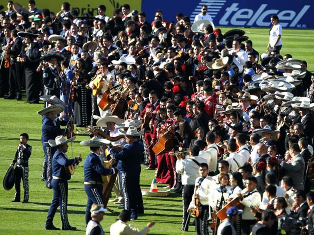 11-year-old Sebastian De La Cruz, far left, joins Los Camperos mariachi band to lead a record breaking attempt of 600 mariachi players performing at the half time show for the Mexico vs Panama in California. (AP)