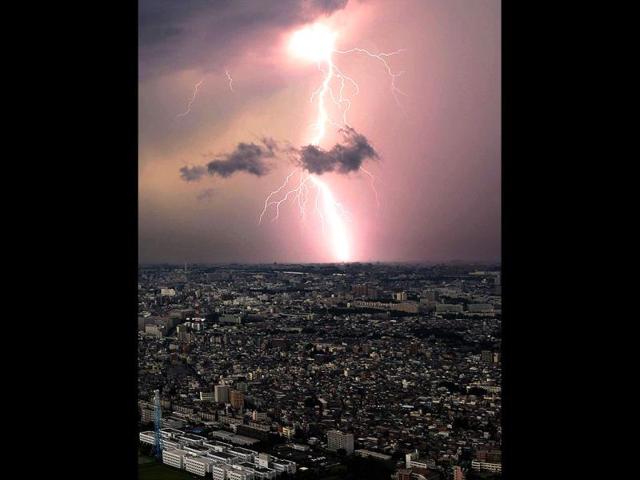 Lightening flashes over Saitama prefecture in Tokyo, Japan. (AP Photo)