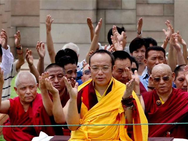 Monks at the inter-faith prayer meeting at Rajghat in New Delhi on Tuesday. (PTI Photo)