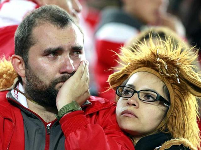 Fans of Colombia's Santa Fe react after their team lost to Paraguay's Olimpia during the Copa Libertadores in the second leg semi-final soccer match in Bogota. Reuters