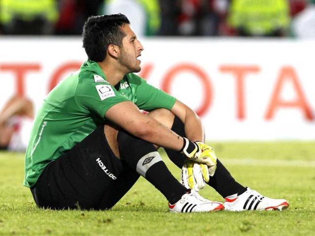 Colombia's Independiente Santa Fe's goalkeeper Camilo Vargas sits on the field after his team lost to Paraguay's Olimpia at the end of Copa Libertadores semifinal soccer match in Bogota, Colombia. AP