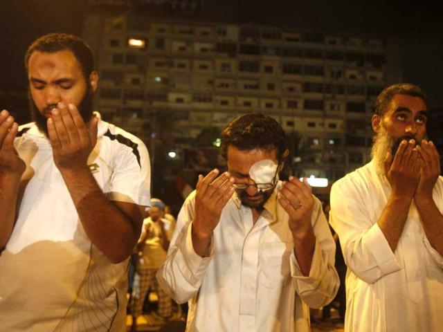Supporters of deposed Egyptian President Mohamed Morsi recite prayers to start the day's fasting, outside Rabaa Adawiya mosque in Cairo. Reuters