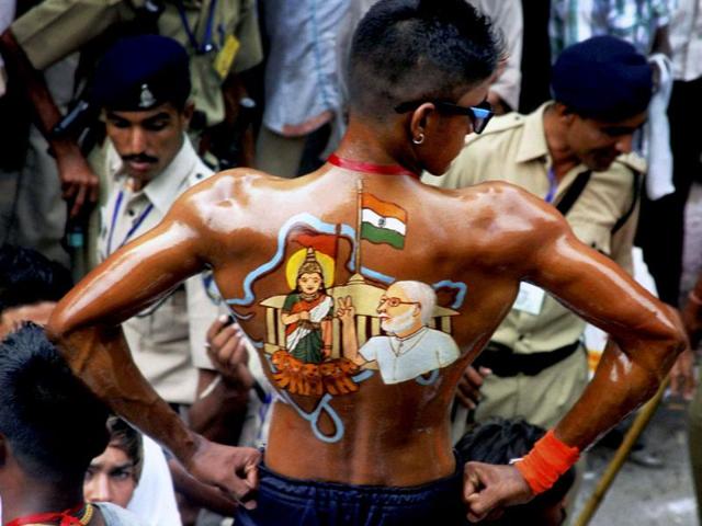 A devotee with colourful illusrations on his his back with an image during the 136th annual Rath Yatra in Ahmedabad. PTI Photo