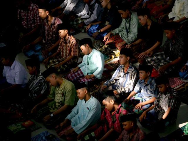 Students perform an afternoon prayer on the first day of the holy fasting month of Ramadan, at Ar-Raudlatul Hasanah Islamic boarding school in Medan, North Sumatra, Indonesia, Wednesday, July 10, 2013. During Ramadan Muslims refrain from eating, drinking, smoking and sex from dawn to dusk. (AP Photo)
