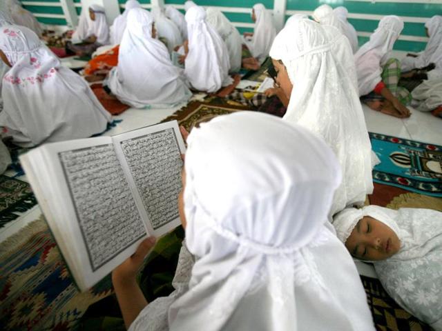 Students read the Quran on the first day of the holy fasting month of Ramadan, at Ar-Raudlatul Hasanah Islamic boarding school in Medan, North Sumatra, Indonesia, Wednesday, July 10, 2013. During Ramadan Muslims refrain from eating, drinking, smoking and sex from dawn to dusk. AP Photo