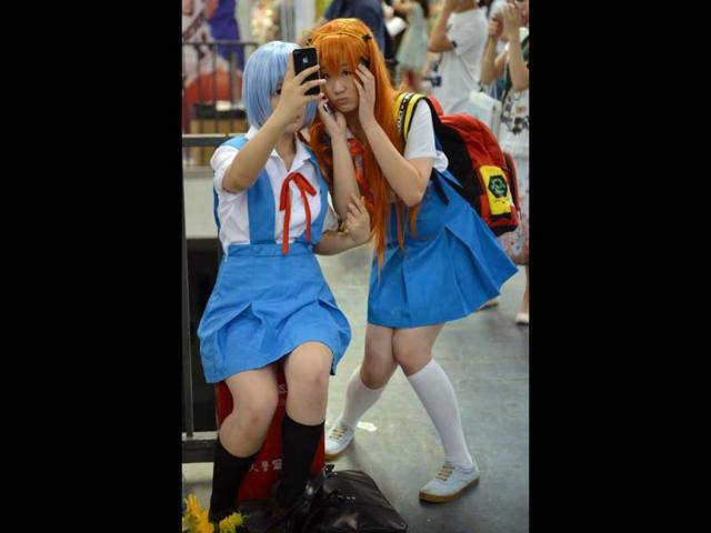 Cosplay fans take photos of each other on the opening day of the 9th China International Comics Games Expo (CCG Expo) in Shanghai. AFP Photo