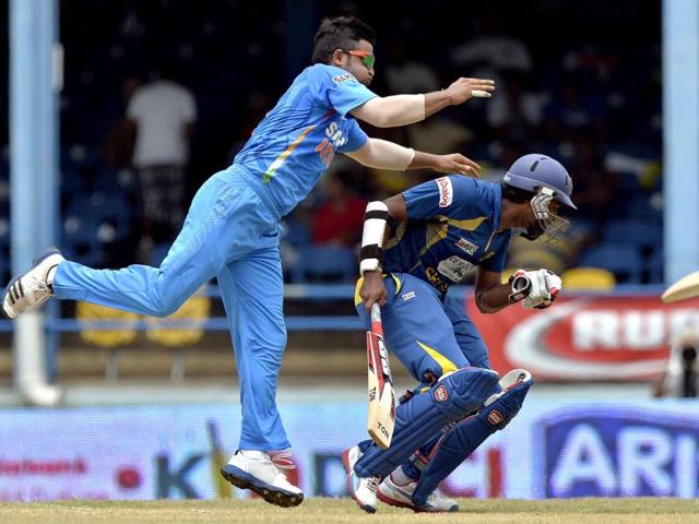 Suresh Raina collides with Lahiru Thirimanne as he tries to field the ball during the Tri-Nation series final at the Queen's Park Oval stadium in Port of Spain. AFP Photo