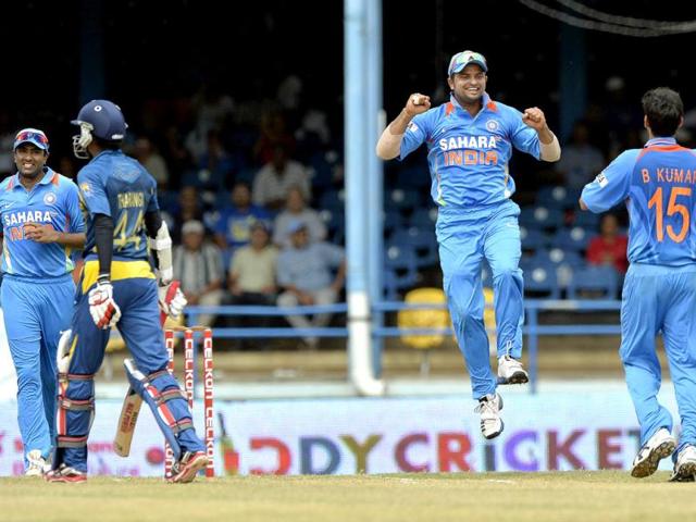 Bhuvneshwar Kumar celebrates after dismissing Upul Tharanga during the Tri-Nation series final at the Queen's Park Oval stadium in Port of Spain. AFP PHOTO