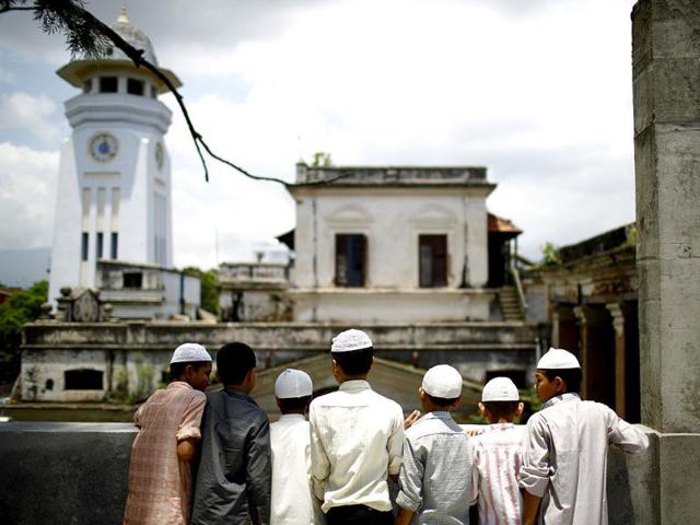 Nepalese Muslim boys look out from the roof of a mosque as they wait to offer Friday prayers during the Muslim holy month of Ramadan in Kathmandu. Reuters