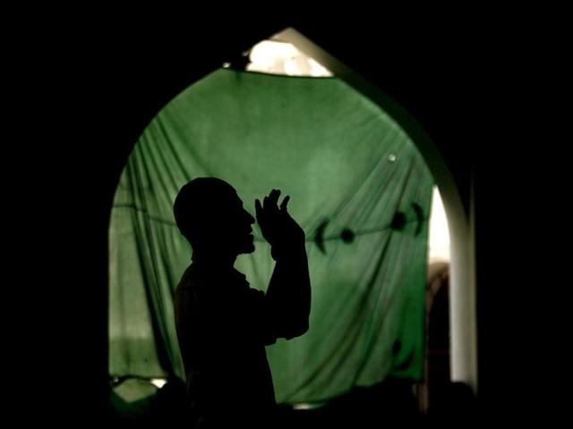 A Muslim man is silhouetted as he prays at a mosque during the month-long fasting on Ramadan in Colombo. Reuters
