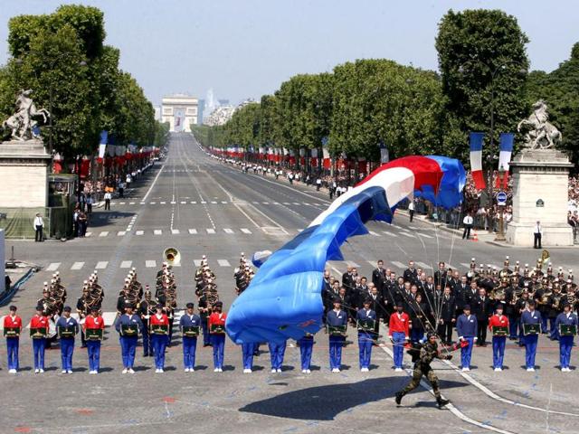 A paratrooper lands on Concorde Square during the Bastille Day parade in Paris. (AP Photo)