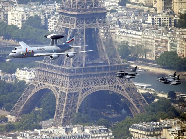 A military Airborne Warning and Control Systems aircraft flys past the Eiffel tower as part of the traditional Bastille Day parade in Paris. (Reuters Photo)